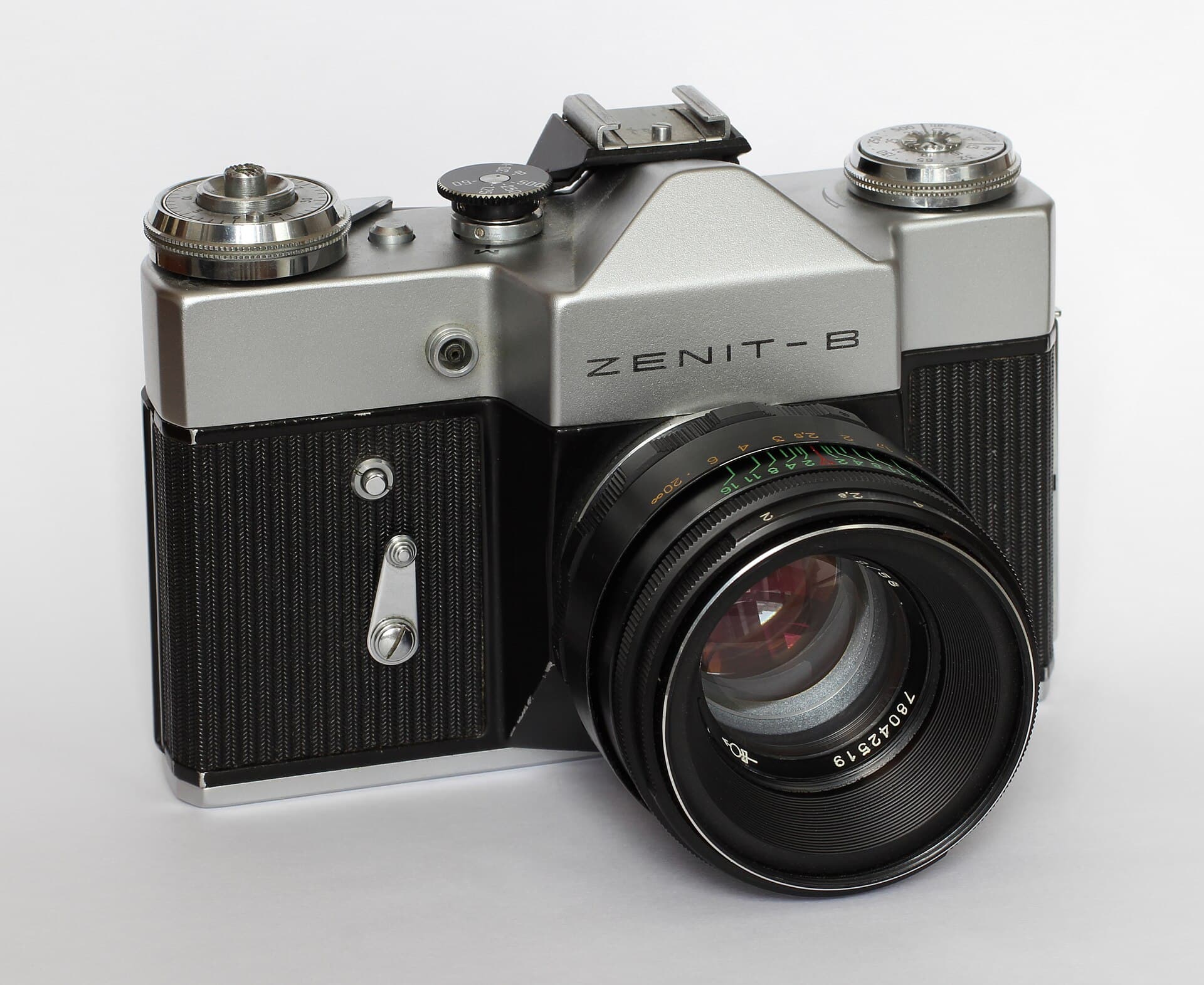 A Zenit-B 35mm film camera with a Helios lens, photographed on a white background.